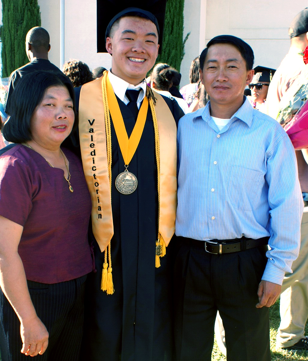 Vang and his proud parents after his high school graduation.