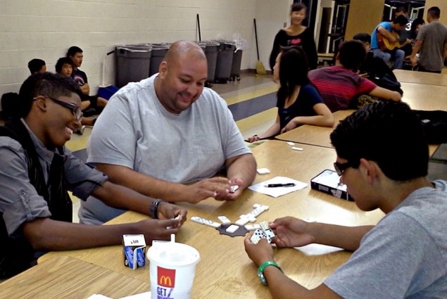 Special ed teacher and students playing dominoes