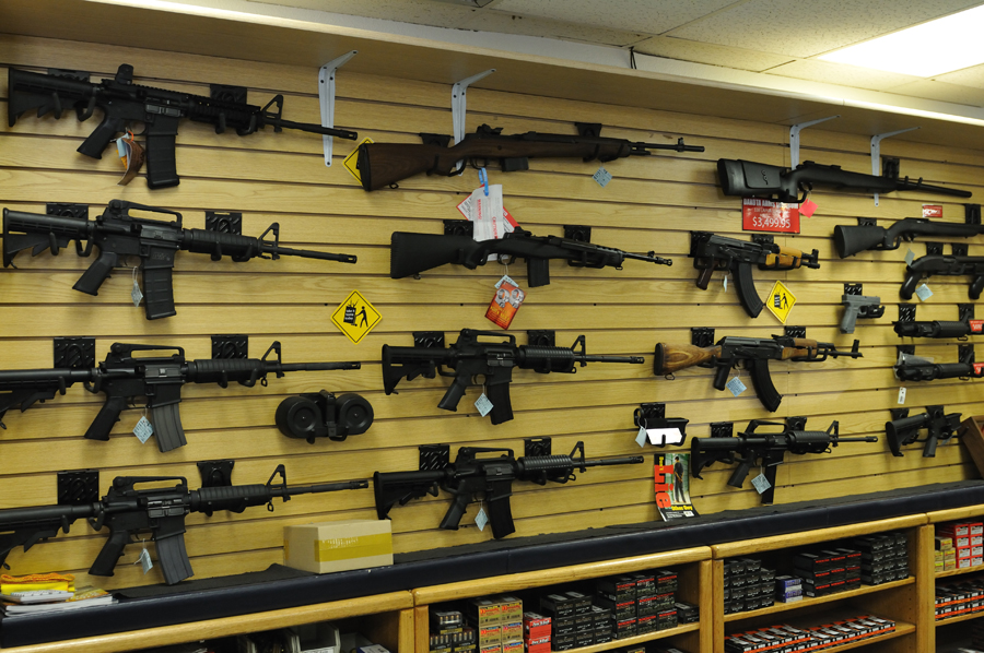 wall of high powered rifles on display for sale