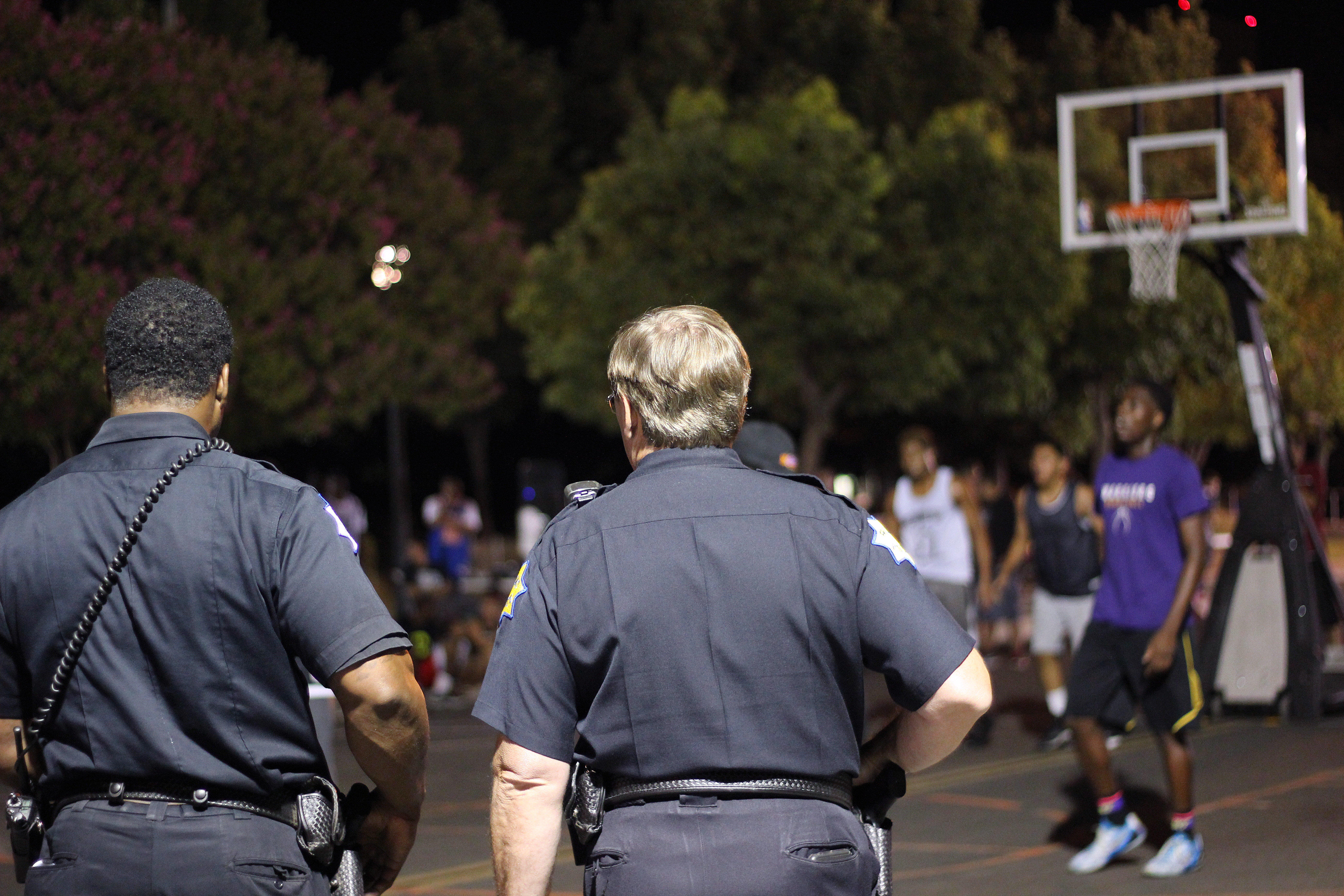 Police officers watch as the games go on in downtown Fresno. 