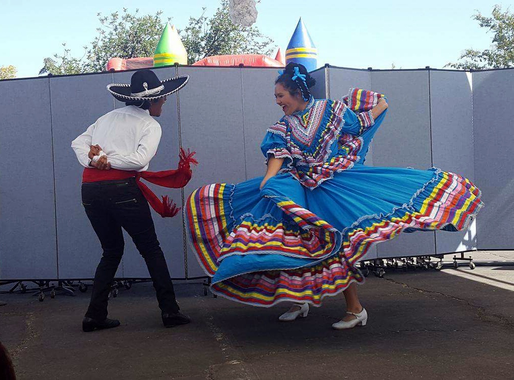 Ricardo Cortez and Alexis Rodriguez dancing in the traditional Jalisco region attire. 